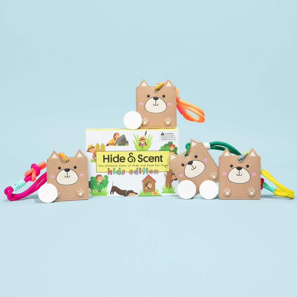 Hide&Scent all styles: Lola (yellow), Cooper (orange), Buddy (green), and Daisy (pink) ropes with bear pouches and scent stones, along with the Kids Edition game box, designed as problem-solving games for dogs.